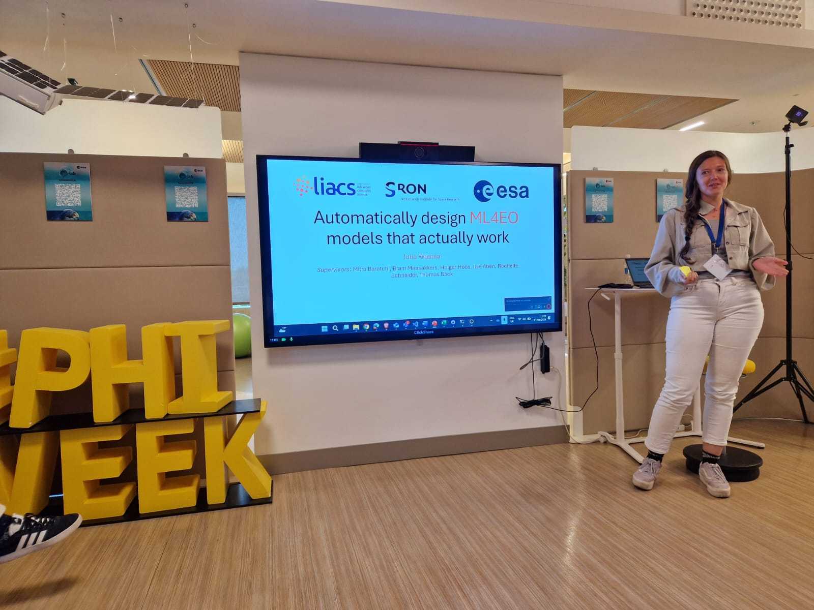 An photo of me presenting my title slide at ESA Φ-Lab.